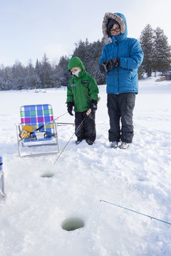 Mixed Race Family Ice Fishing