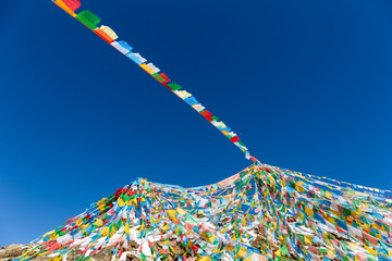 the wind-horse flags on tibet against a blue sky