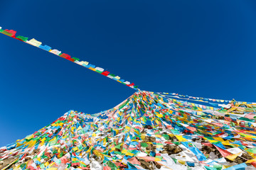 the wind-horse flags against a blue sky