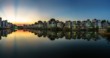 Fototapeta premium Hanoi cityscape at sunset. Resident buildings by Tien Bien lake, Gia Lam district