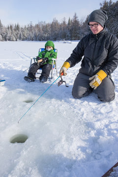 Mixed Race Family Ice Fishing