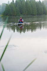 Fototapeta na wymiar Middle aged man kayak fishing