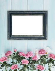 Wooden background with frames, roses and orchid flowers
