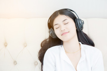 Relaxed woman listening to music in the living-room at home