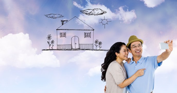 Happy couple taking selfie with house drawn on clouds
