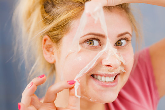 Woman Peeling Off Gel Mask From Face