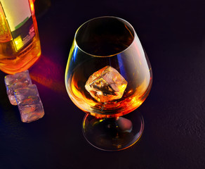 whisky drink with ice on black background.