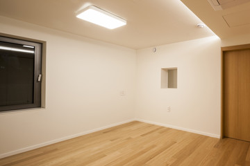 empty white room with wood door.