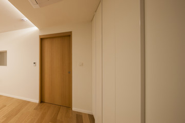 empty white room with wood door.