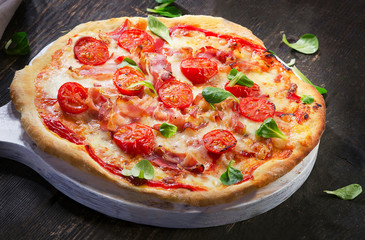 Homemade Pizza  on a dark wooden table