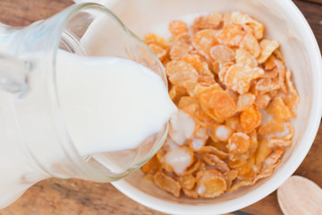 Milk splashes into corn flakes bowl