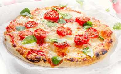 Italian Pizza on white wooden board.