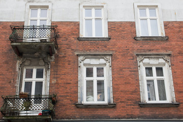 Fototapeta na wymiar Vintage design windows with a balcony on the facade of the old house