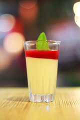 delicious dessert panna cotta in a glass and fresh strawberries
