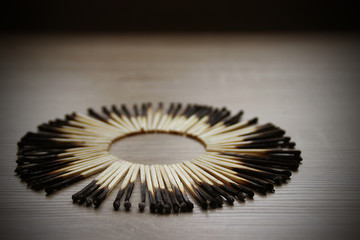 Burnt matches arranged in a circle