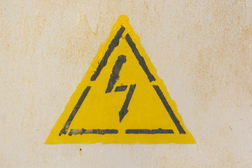 High voltage sign on grey wall