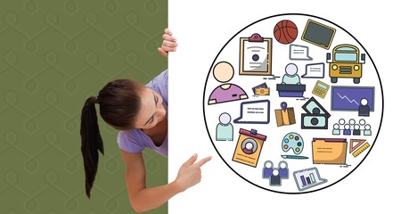 Digital composite image of woman pointing at icons on bill board