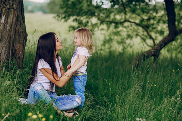 child near tree with mom