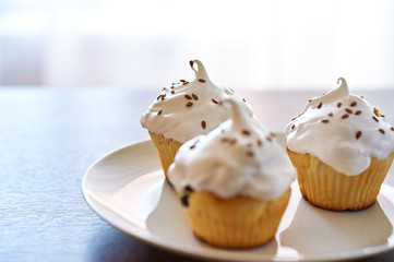 Cupcakes with white cream on the plate
