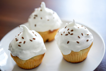 Cupcakes with white cream on the plate