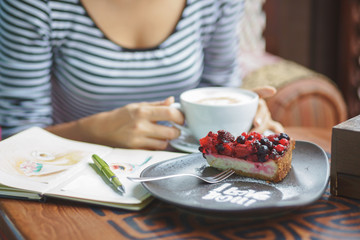 Young woman sitting indoor in urban cafe