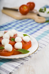 Caprese salad on a wooden table.