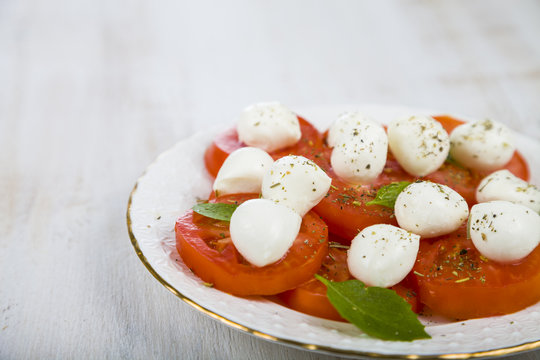 Caprese salad on a wooden table.