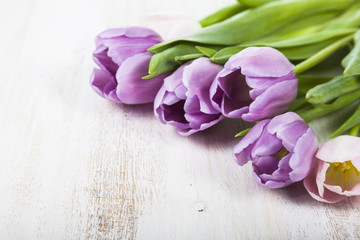 Bouquet of tulips on a wooden background.