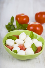 Caprese salad on a wooden table.