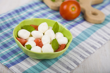 Caprese salad on a wooden table.