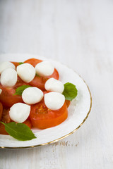 Caprese salad on a wooden table.