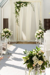 Fototapeta na wymiar White wedding ceremony decorations indoor. Wedding when bad weather
