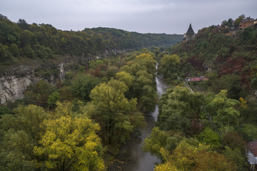 A watchtower above the canyon of the Smotrych River in Kamianets-Podilskyi, Western Ukraine. Trees...