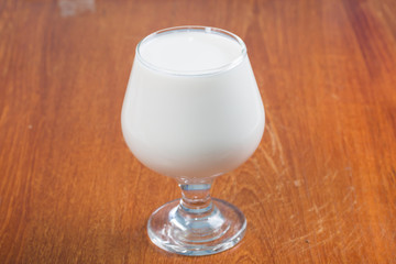 Milk in glass isolated on wooden table
