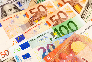 Background of different currency. Euro banknotes and american dollars
