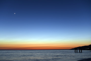 Sunset over the Black sea with a new moon