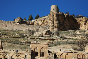 Historical mardin castle with clear sky.  Ruined tower of mardin castle from artuqids period.  