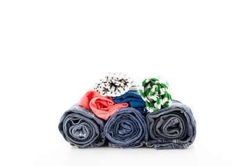 pile of clothes ,rolls jean and colorful shirt isolated on white background.