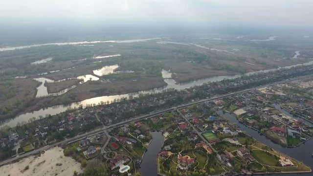 Air footage. Flight over a beautiful village by the river