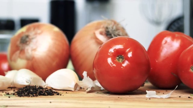 Tomato, garlic, onions, herbs on a wooden chopping board - 1 of 4