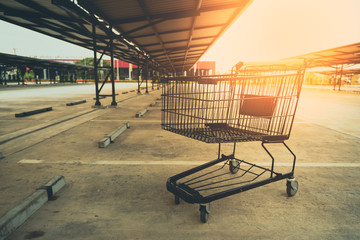Shopping cart in parking lot. © amornchaijj