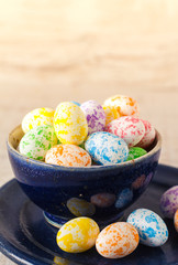 Colorful mini easter eggs in a bowl, close up