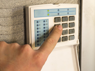 Security alarm keypad with male hand
