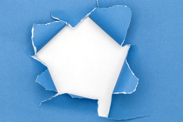 Blue ripped open paper on white paper background.