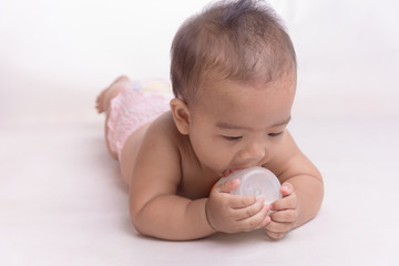 baby tries to suck milk from the bottle.