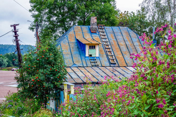 Colorful blue rusty roof of a rural house in the suburbs