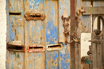 Letterboxes in distressed door