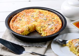 Slice of cheese casserole served with honey