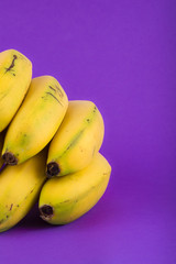 bunch of bananas on violet background