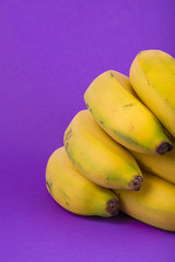 bunch of bananas on violet background
